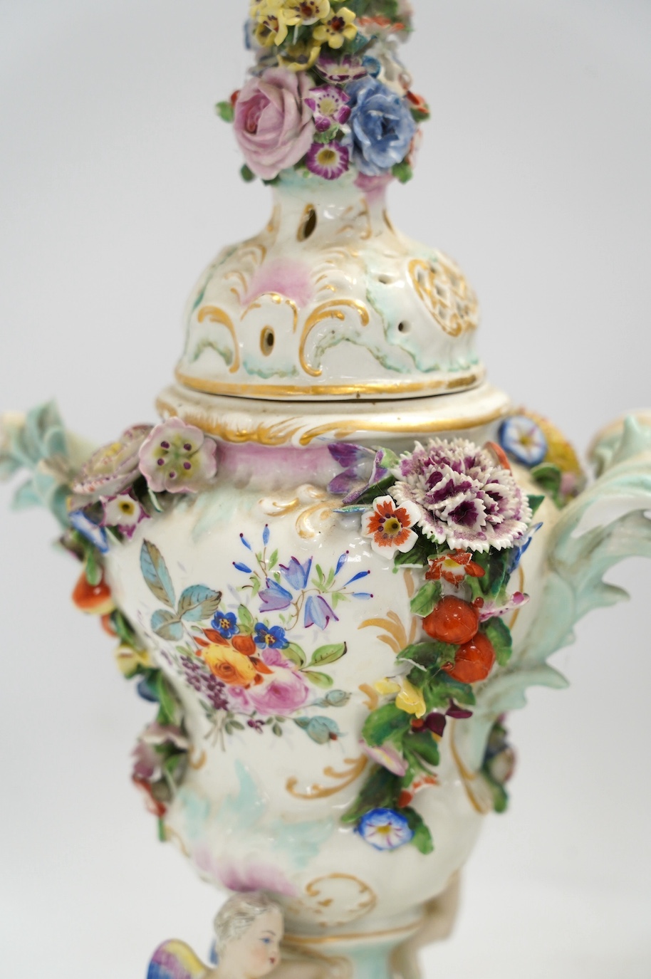 A pair of Potschappel porcelain floral encrusted vases and covers, 31cm high. Condition - poor